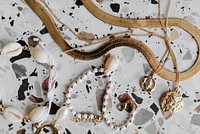 Aerial view of gold jewelries on a white marble background