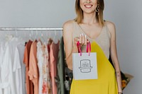Happy woman carrying a shopping paper bag mockup