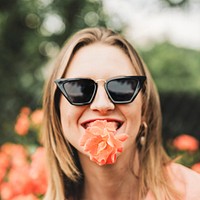 Cheerful woman with an orange rose