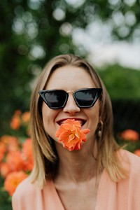 Cheerful woman with an orange rose