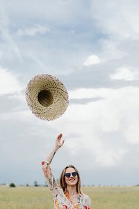 Woman throwing hat into the air