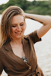 Caucasian womanis smiling by the water