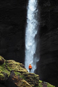 Female hiker with a view of Kvernufoss waterfall in South Iceland