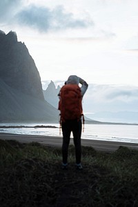 Photographer on a green hill at the Stokksnes peninsula in Southeast Iceland