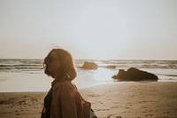 Woman strolling the beach at sunset