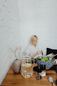 Expecting mother reading a book in the kitchen