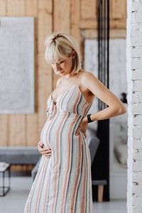 Pregnant blond-haired woman in a living room