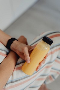 Woman holding a bottle of orange juice