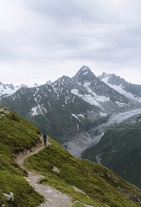 Man walking on a footpath up the French alps