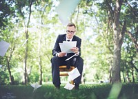 Buisness man outdoors reading a paper