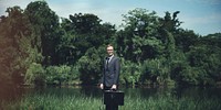 Businessman with his suitcase in nature