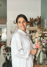 Cheerful woman in the flower shop