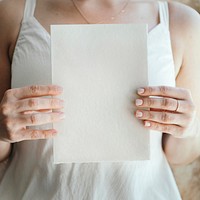 Bride holding a blank white card