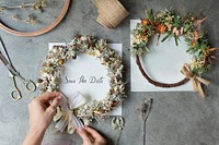 Woman tying a ribbon on a floral wreath