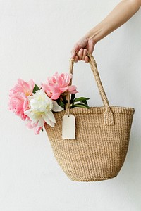 Beautiful peonies in a wicker bag