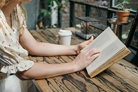 Woman reading a novel at a cafe