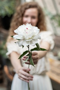 Woman with a white paeonia snowboard flower