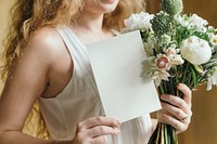 Woman holding a bouquet of white flowers with a card mockup