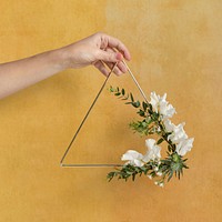 Girl holding a leaf decorated triangle golden frame