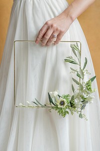 Girl holding a leaf decorated golden frame