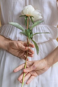 Woman with a white paeonia snowboard flower