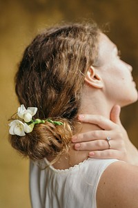 Girl with white freesia flowers in her hair