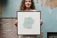 Cheerful woman holding a picture frame mockup