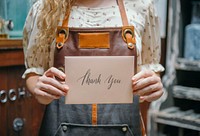 Florist holding up a thank you card