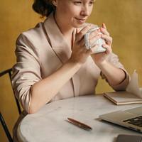 Beautiful businesswoman working on her laptop at a cafe