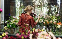 Florist arranging lisianthus in her shop