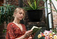 Florist reading a book in the flower shop