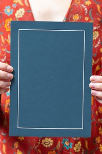 Woman holding a blue framed card mockup