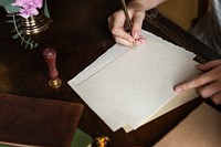 Woman writing a letter on a blank paper mockup