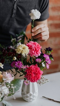 Man arranging flowers in a vase