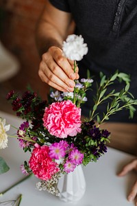 Man arranging flowers in a vase