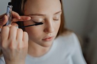 Beauty blogger applying mascara to her model