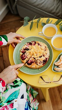 Woman cutting a slice of plum crumble pie