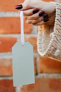 Woman holding a white tag mockup