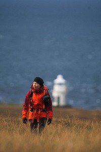 Female photographer at Vaternish Lighthouse on Isle of Skye, Scotland