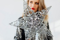 Woman holding a silver wire Christmas star