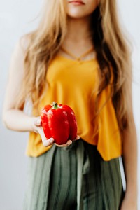 Woman holding a red bell pepper