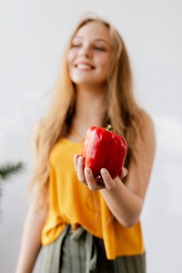 Woman holding a red bell pepper