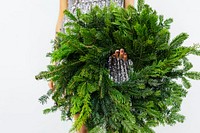 Woman holding a green Christmas wreath 