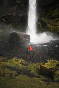 Female hiker with a view of Kvernufoss waterfall in South Iceland