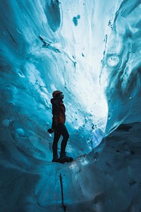 Female photographer in the ice cave, Iceland