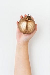 Woman holding a gold bauble