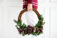 Woman carrying a fresh Christmas wreath