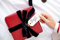 Woman holding a red present with a card