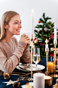 Blond woman having a romantic Christmas dinner