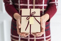 Woman holding a gold present with a card